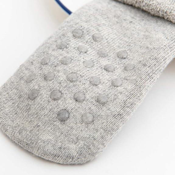 Close Up Photo Of Gray Christmas Baby Socks Foot Pads In A White Background