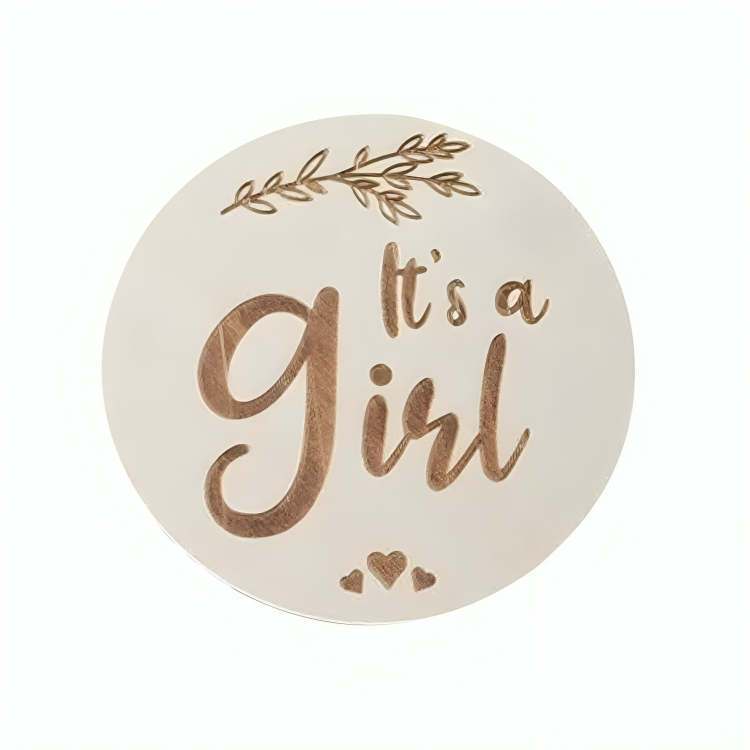 Round It's a Girl announcement badge with decorative elements in a white background