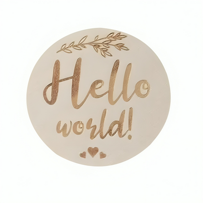 Round decorative object with the phrase Hello world! in brown script on a light background.