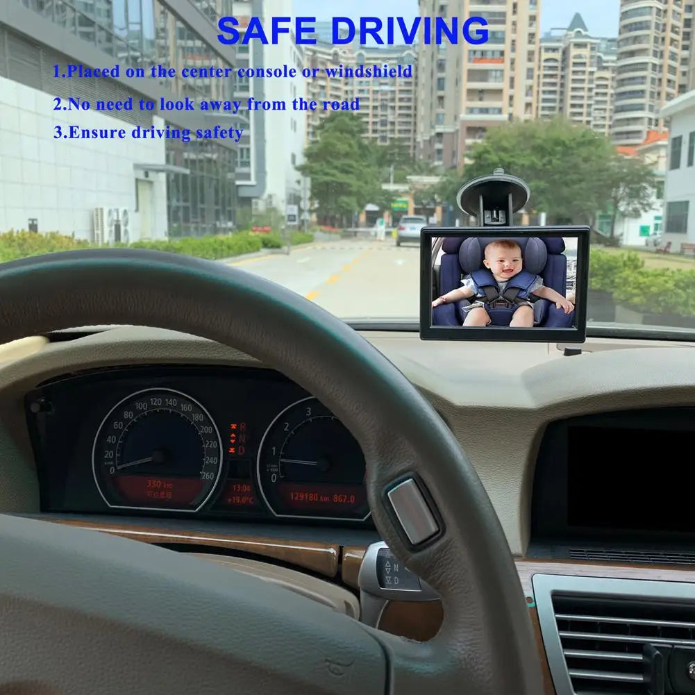 A Car Seat Baby Monitor Attached In Front Car Window Featuring Safe Driving text