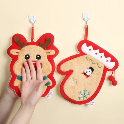 Two Christmas Themed Hanging Towel Attached To A Nude Color Wall With Person Wiping His Hand On One Of The Towel