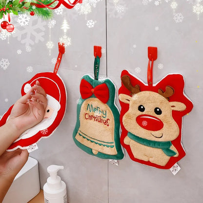 Three Christmas Themed Hanging Towel Attached To A Gray Wall With Person Wiping His Hand On One Of The Towel