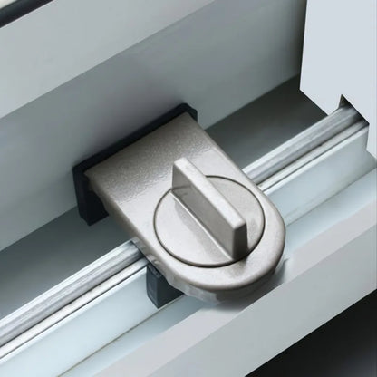 Gray Sliding window lock installed on a sliding window