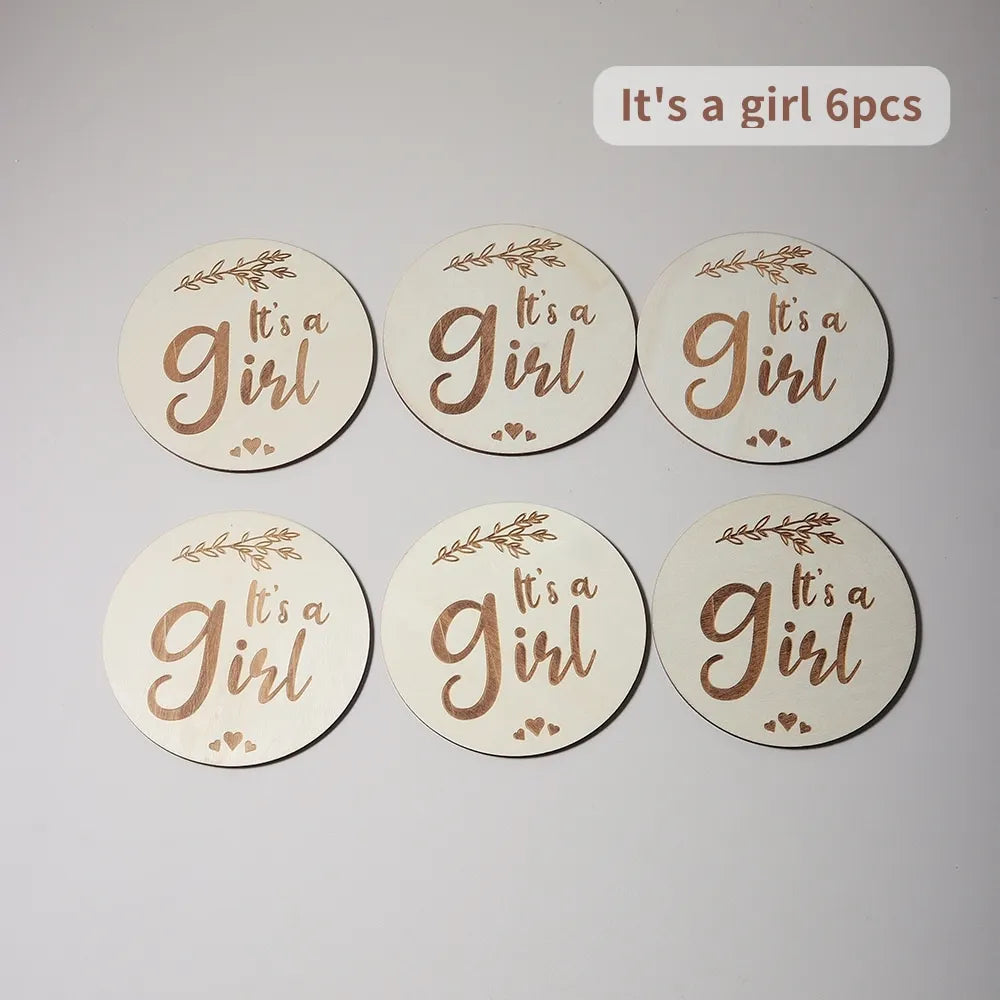 Set of six circular discs with It's a Girl text, adorned with small hearts and foliage.