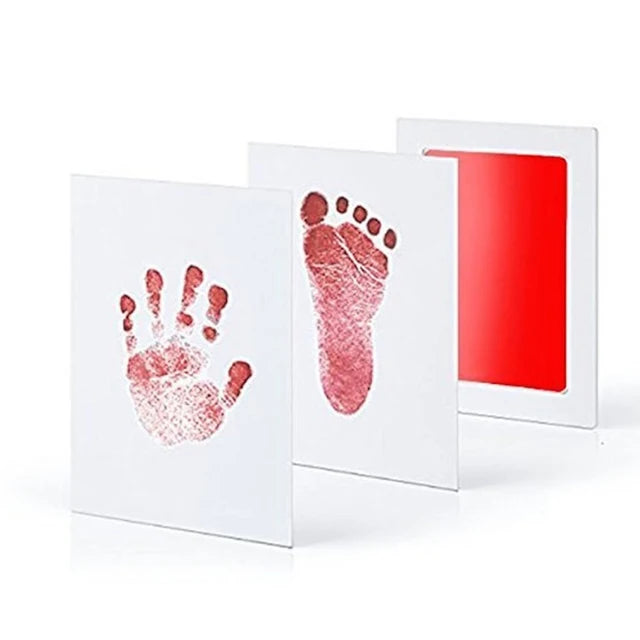 Three canvas panels with red baby handprint, footprint, and plain red color.