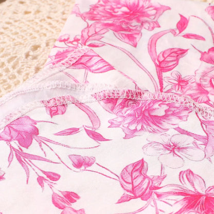 Close-up of pink floral fabric with lace trim.