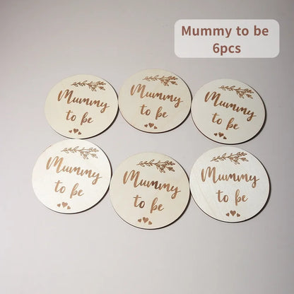 Six wooden discs with Mummy to be text and leaf motifs.