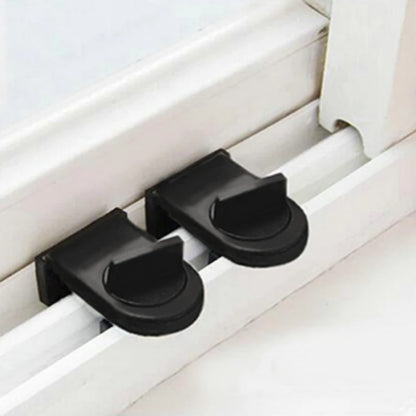 Two Black Window sliding lock installed on a sliding window