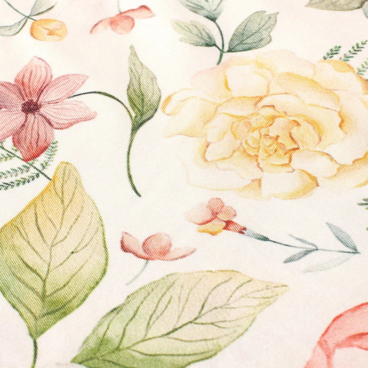 Floral fabric texture with printed pink and yellow flowers and green leaves.