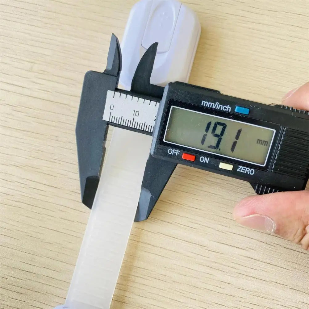 Digital caliper measuring the width of an object at 19.1 mm, with a human hand in the background.